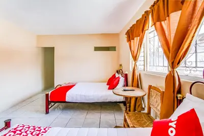 Cama o camas de una habitación en OYO Hotel Margarita