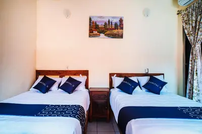 Cama o camas de una habitación en Capital O Hotel Aurora, Tuxtla Gutiérrez