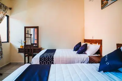 Cama o camas de una habitación en Capital O Hotel Aurora, Tuxtla Gutiérrez
