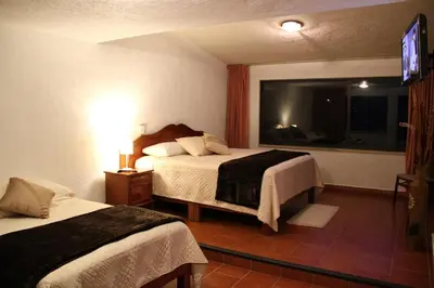 Cama o camas de una habitación en Hotel Quinta del Sol