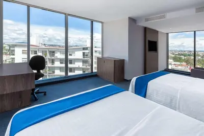Cama o camas de una habitación en Wyndham Puebla Angelopolis
