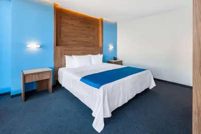 Cama o camas de una habitación en Wyndham Puebla Angelopolis