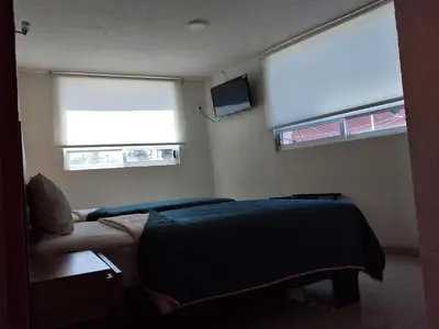 Una televisión o centro de entretenimiento en HOTEL SAN JOSE