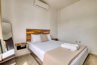 Cama o camas de una habitación en La Aurora Puerto Escondido