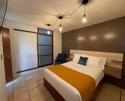 Cama o camas de una habitación en Hotel Orquídea