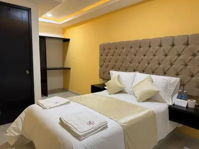Cama o camas de una habitación en OYO Hotel Familiar Tollan Cholula