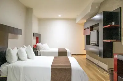 Cama o camas de una habitación en Hotel Cancalli Tlaxcala