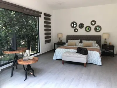 Cama o camas de una habitación en Casa Huitzil - La mejor casa de Malinalco con alberca y jacuzzi climatizados