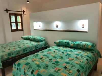 Cama o camas de una habitación en Cabañas las Palmas Chacahua