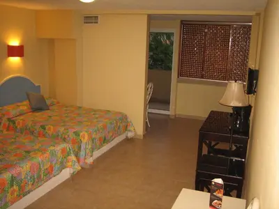 Cama o camas de una habitación en Hotel Delfines Acapulco by NG Hoteles