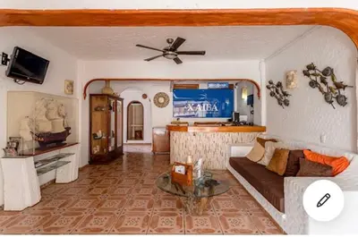 Una televisión o centro de entretenimiento en HOTEL VILLAS XAIBA