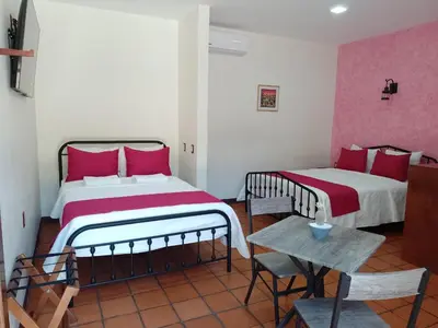 Cama o camas de una habitación en Casa de las flores Hotel Boutique