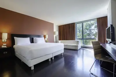 Cama o camas de una habitación en NH Puebla Centro Histórico
