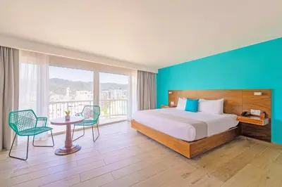 Cama o camas de una habitación en Hotel Amares Acapulco