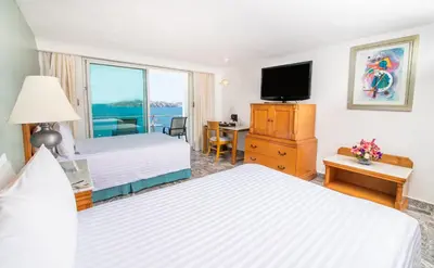 Cama o camas de una habitación en Emporio Acapulco