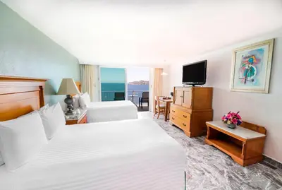 Cama o camas de una habitación en Emporio Acapulco