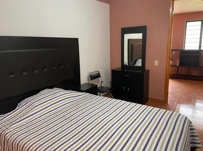 Cama o camas de una habitación en Departamento con gran área verde