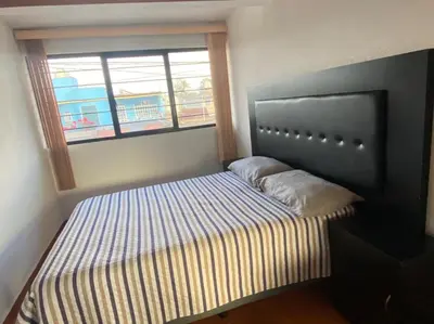 Cama o camas de una habitación en Departamento con gran área verde