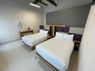 Cama o camas de una habitación en Hotel Alhaja Puebla Centro Histórico