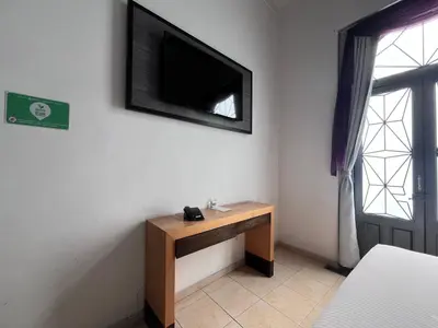 Una televisión o centro de entretenimiento en Hotel Alhaja Puebla Centro Histórico