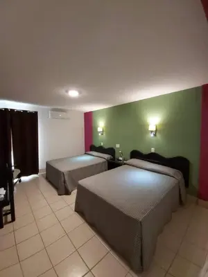 Cama o camas de una habitación en Hotel Aurora