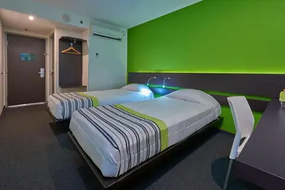 Cama o camas de una habitación en City Express Junior by Marriott Puebla FINSA
