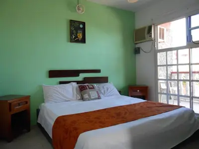 Cama o camas de una habitación en Hotel y Bungalows Monteverde