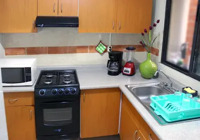 Una cocina o zona de cocina en Casa Palmera con Aire acondicionado Alberca Wifi cocina y TV