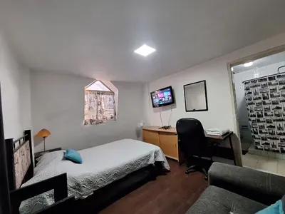 Una televisión o centro de entretenimiento en Casa Miranda Airport