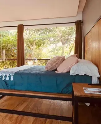 Cama o camas de una habitación en Hotel Garden Suites Tonalá
