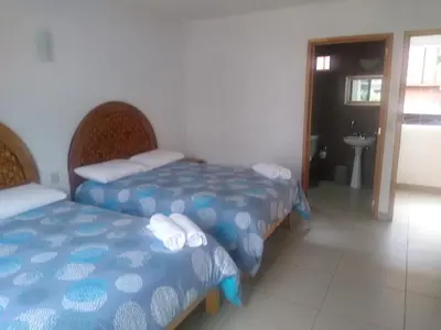 Cama o camas de una habitación en Hospedaje Anayauhcalli