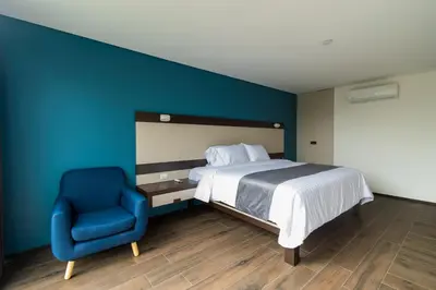 Cama o camas de una habitación en Hotel Balcón del Parque
