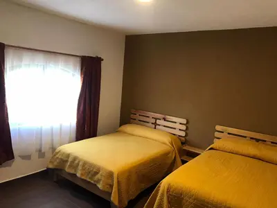 Cama o camas de una habitación en Hostal Casa Flor de Limón