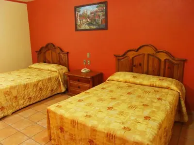 Cama o camas de una habitación en Hotel Oaxaca Dorado