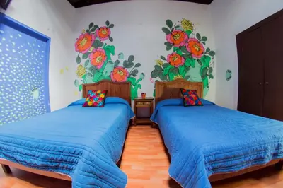 Cama o camas de una habitación en Gente de Más Hostel